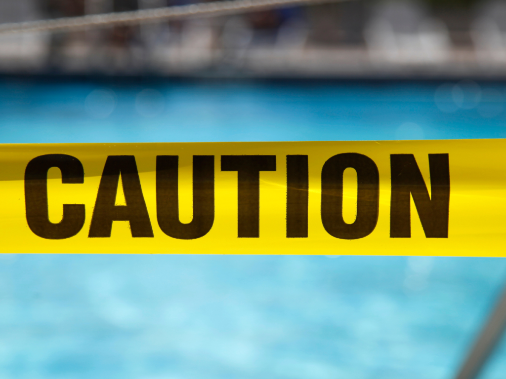 Caution tape in front of a pool